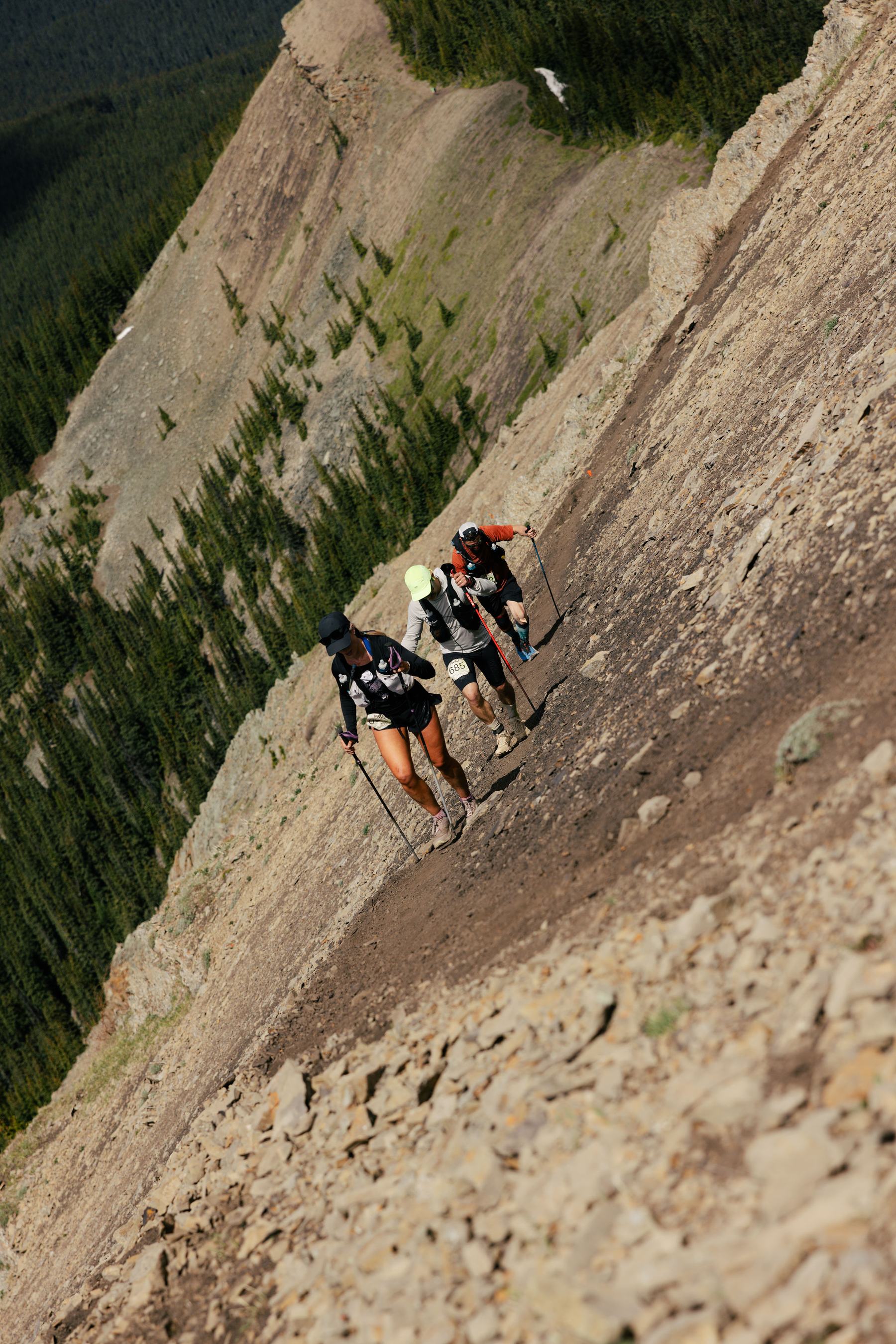 Runners crossing the scree above Aid Station 4